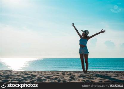 Full Length Of Woman With Arms Outstretched Standing On Shore At Beach