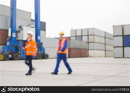Full-length of workers walking in shipping yard