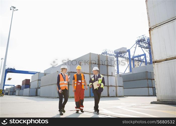 Full-length of workers walking in shipping yard