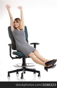 Full length of young business woman sitting on the chair over white background relaxing