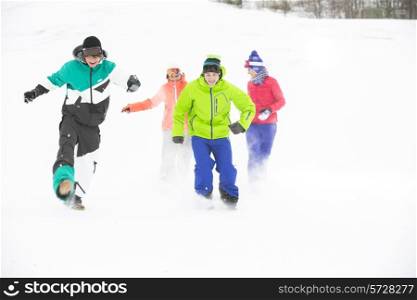 Full-length of young friends having fun in snow