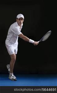 Full length of young male tennis player playing at court