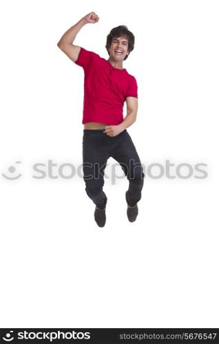 Full length of young man cheering and jumping isolated over white background