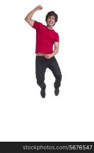 Full length of young man cheering and jumping isolated over white background