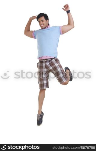 Full length of young man in casuals jumping isolated over white background