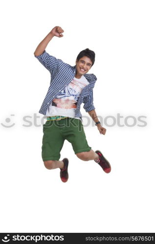 Full length of young man jumping excitedly over white background