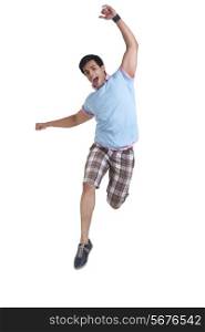 Full length of young man jumping isolated over white background