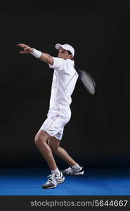 Full length of young man playing tennis at court