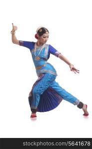 Full length of young woman performing Bharatanatyam