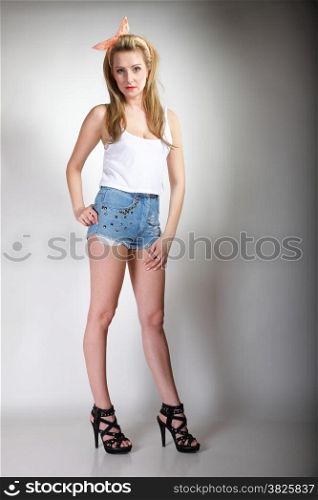 Full length pin up beautiful blonde girl retro styling, studio shot gray background