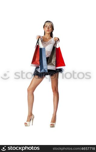 Full length portrait of a beautiful young brunette woman posing with shopping bags, isolated on white background