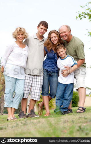 Full length portrait of a happy family standing outdoor