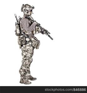 Full length portrait of airsoft player in checkered shirt, wearing camouflage uniform, helmet with tactical radio headset, body armour, aiming with service rifle replica studio shoot isolated on white. Airsoft player aiming service rifle studio shoot