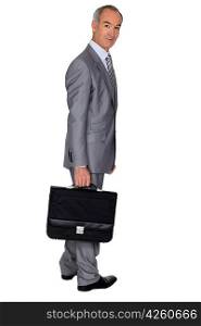 Full length portrait of an older businessman with a briefcase