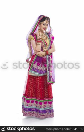 Full length portrait of beautiful bride standing against white background