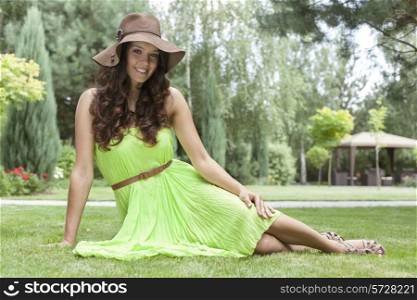 Full length portrait of beautiful young woman in sundress at park