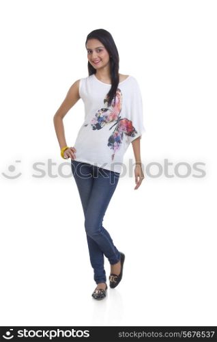 Full length portrait of beautiful young woman posing over white background