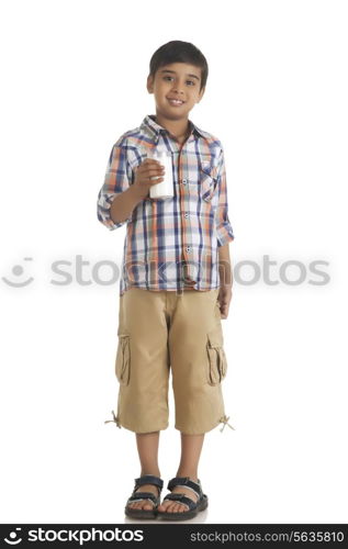 Full length portrait of boy holding milk over white background