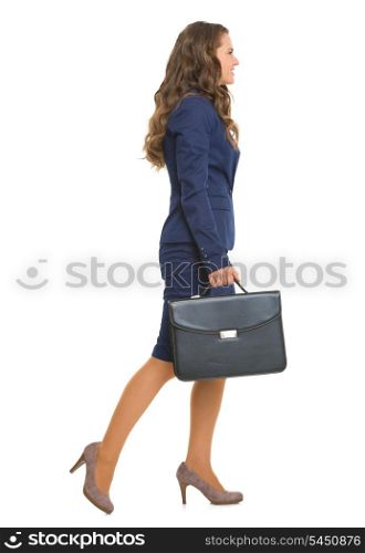 Full length portrait of business woman with briefcase going sideways