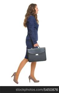 Full length portrait of business woman with briefcase going sideways