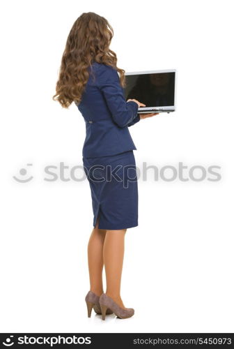 Full length portrait of business woman with laptop . rear view