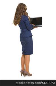Full length portrait of business woman with laptop . rear view