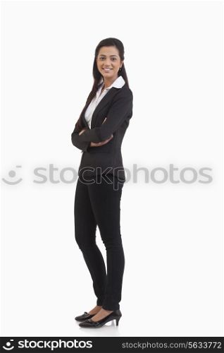 Full length portrait of businesswoman with arms crossed isolated over white background