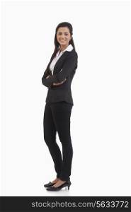 Full length portrait of businesswoman with arms crossed isolated over white background