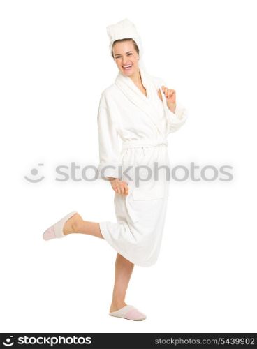 Full length portrait of cheerful young woman in bathrobe