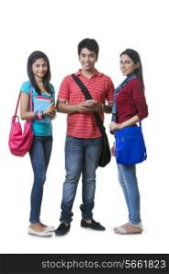 Full length portrait of college students with books and bags against white background