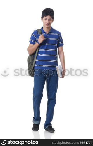 Full length portrait of confident male student with books and rucksack over white background