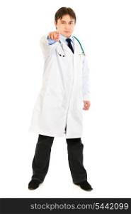 Full length portrait of confident medical doctor pointing finger at you isolated on white&#xA;
