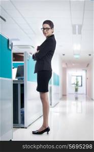Full length portrait of confident young businesswoman in office