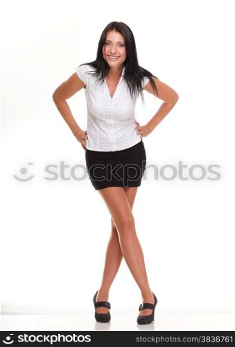 Full length portrait of confident young woman standing with hands folded on white background