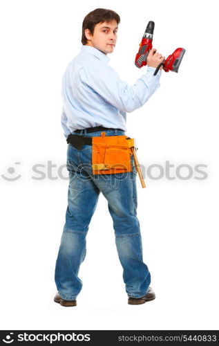 Full length portrait of construction worker with drill look back&#xA;