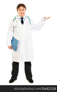 Full length portrait of doctor holding medical chart and presenting something on hand isolated on white&#xA;