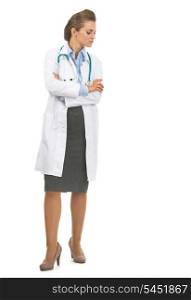 Full length portrait of doctor woman looking down on copy space