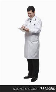 Full Length Portrait of Doctor Writing Medical Record