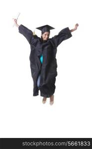 Full length portrait of excited graduate student jumping over white background