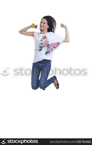 Full length portrait of excited young woman jumping over white background