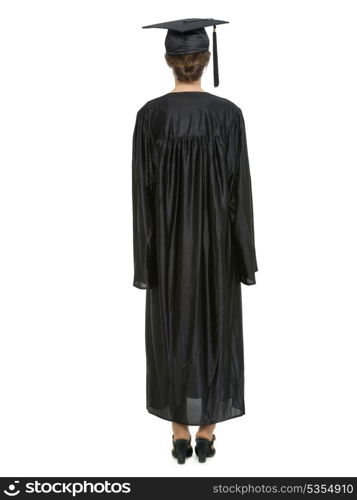 Full length portrait of female in graduation cap and gown standing back to camera. HQ photo. Not oversharpened. Not oversaturated. Full length portrait of female in graduation cap and gown standing back to camera isolated