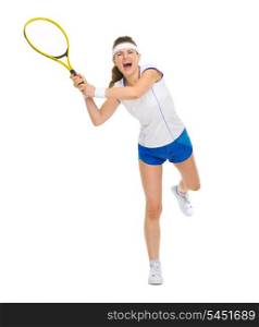 Full length portrait of female tennis player hitting ball