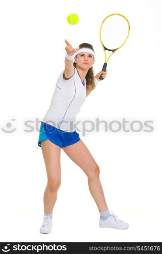 Full length portrait of female tennis player serving ball
