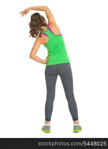 Full length portrait of fitness woman stretching . rear view