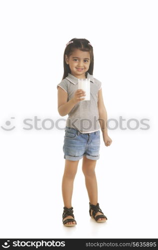 Full length portrait of girl holding milk against white background