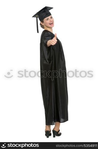 Full length portrait of graduation student woman showing thumbs up. HQ photo. Not oversharpened. Not oversaturated. Full length portrait of graduation student woman showing thumbs up isolated