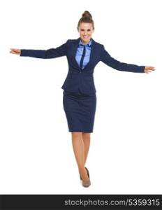 Full length portrait of happy business woman balancing