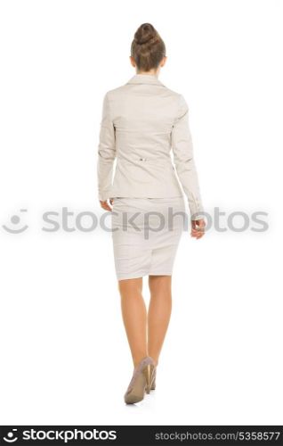 Full length portrait of happy business woman going straight . rear view
