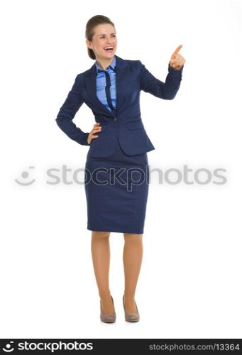 Full length portrait of happy business woman pointing on copy space