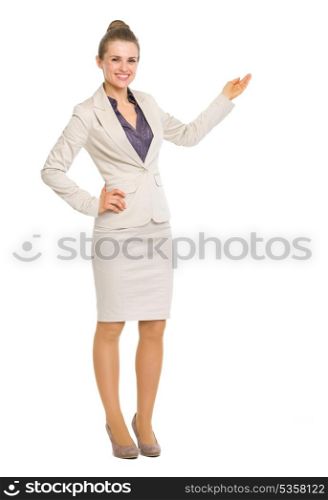 Full length portrait of happy business woman pointing on copy space